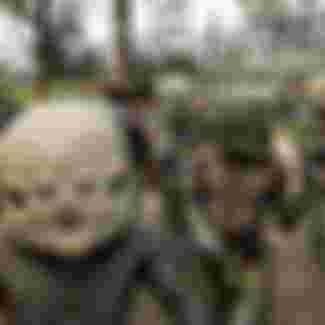 saro mud men from Goroka walk to the annual sing-sing cultural festival in Mount Hagen in 2004. Over 70 tribes put aside their ethnic tensions to come together once a year in the remote frontier town to celebrate the cultural diversity of Papua New Guinea. Credit: TORSTEN BLACKWOOD/AFP via Getty Images