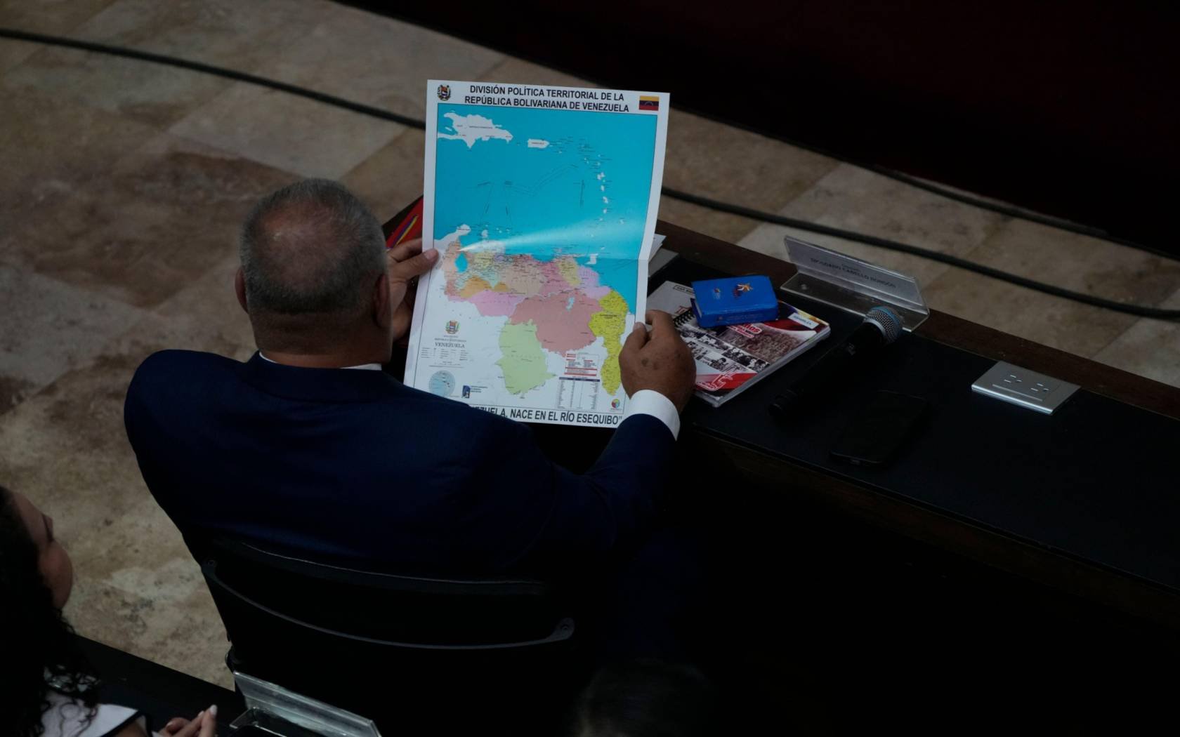 Venezuelan lawmaker Diosdado Cabello, looks at a new map of Venezuela with the Essequibo territory.