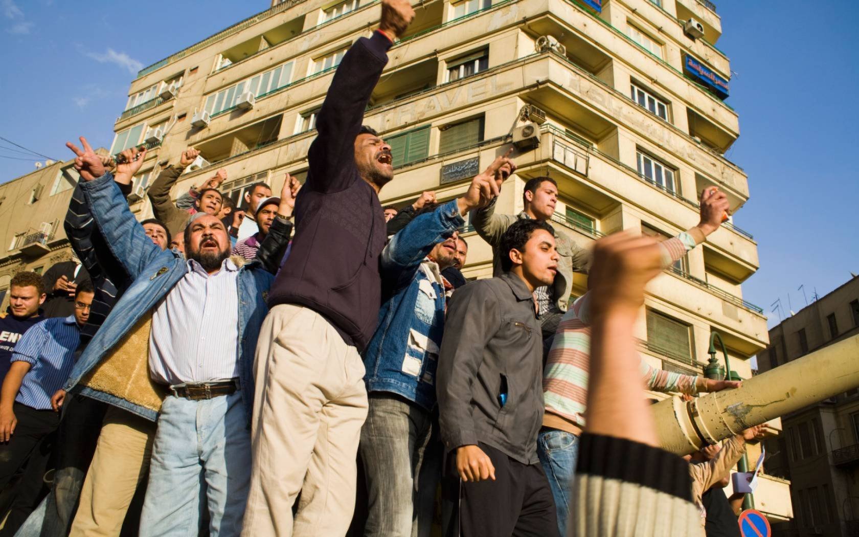 Anti-government protesters celebrate on a tank in Tahrir Square, Cairo, on the first full day of the square's occupation in January 2011.