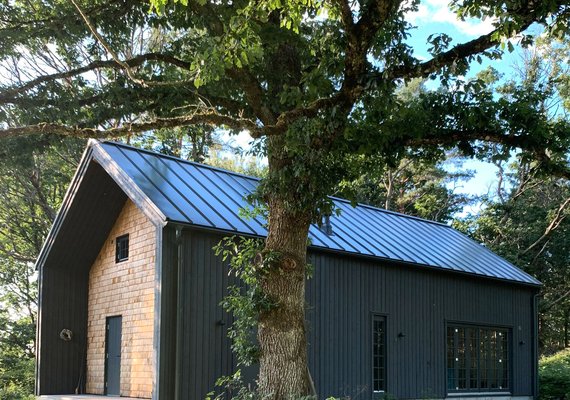 Dark finish single family residence with overhang facade detail
