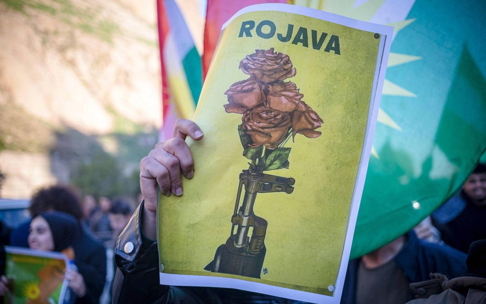 Protesters hold posters during a demonstration against a Turkish military operation against Kurdish People's Defense Units (YPG) forces in Syria's Afrin, outside the Kurdistan Parliament in Erbil, northern Iraq, on January 21, 2018.