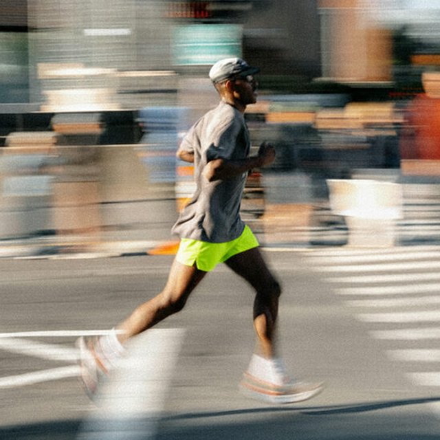 Man in green shorts running in the streets