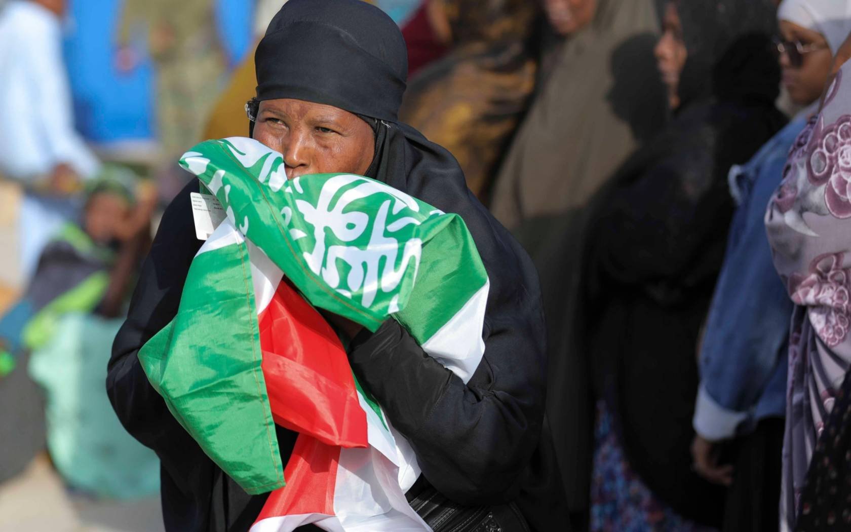 A woman kisses the flag of Somaliland after voting in the 2024 presidential election.