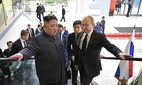Vladimir Putin, right, with North Korean leader Kim Jong-Un on an escalator together after arriving for bilateral discussions on April 25, 2019 in Vladivostok, Russia.