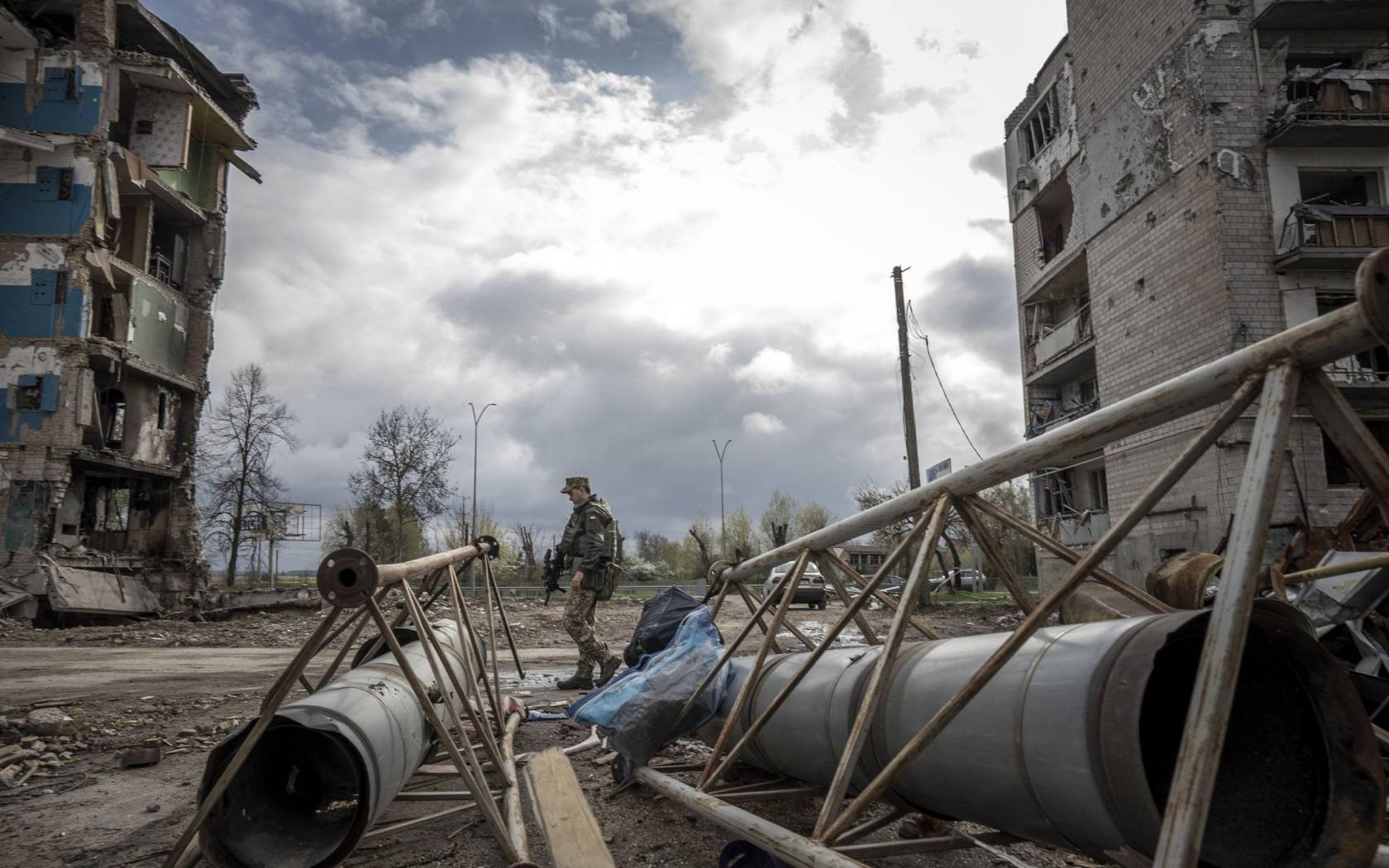 A Ukrainian soldier member walks through a neighbourhood destroyed by Russian missiles in Borodyanka, Ukraine, April 2022.