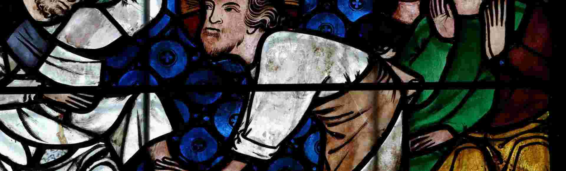 A stained glass window in Strasbourg Cathedral of Christ washing the feet of the Apostles.