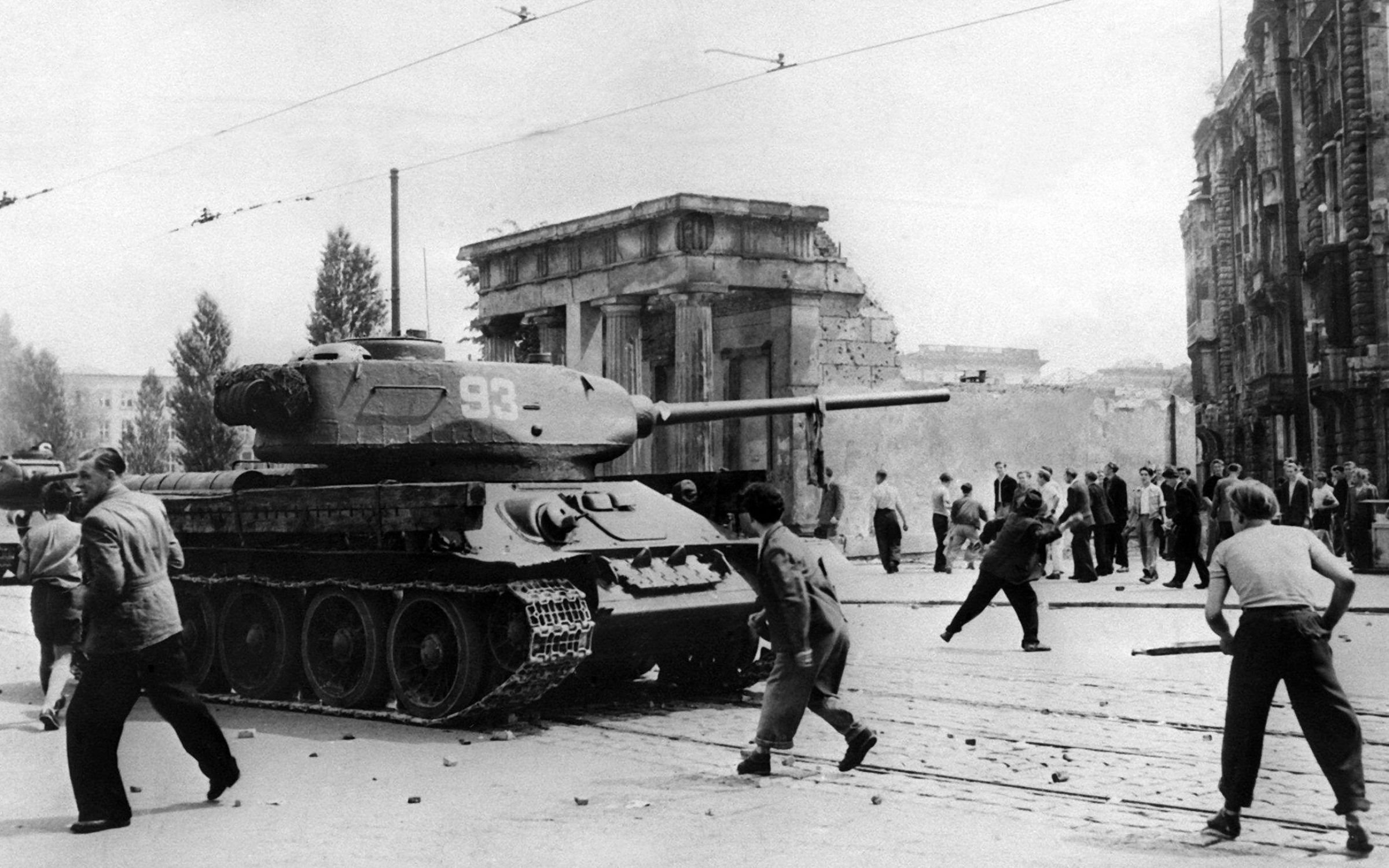 Demonstrators throw stones at Soviet tanks in Berlin during the East German uprising of June 17 1953.