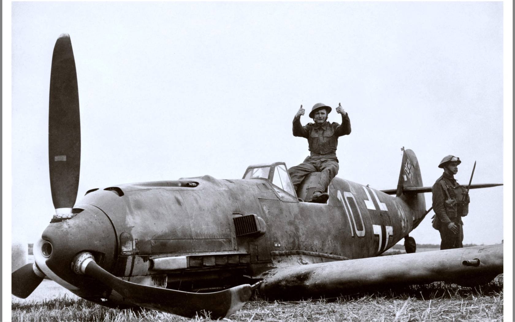 British Soldiers pose with Nazi Luftwaffe Messerschmitt Bf 109E-4 which crash-landed at East Langdon in Kent, 24 August 1940.