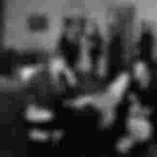 President John F. Kennedy (left, in rocking chair) meets the newly-appointed US Ambassador to West Germany, George McGhee.