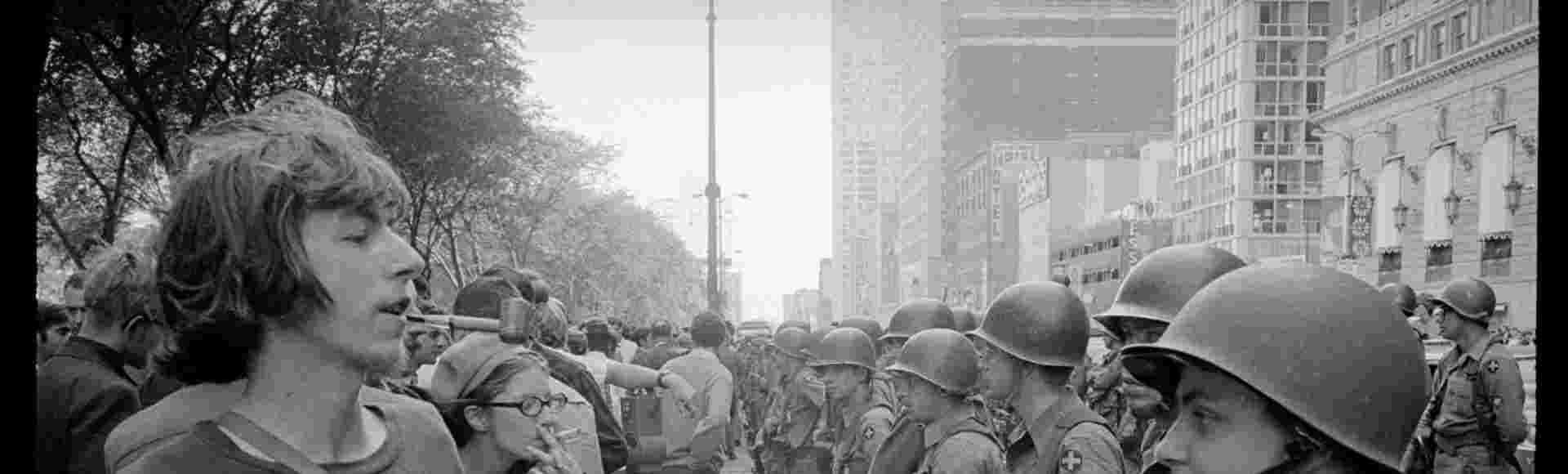 A young 'hippie' stands in front of a row of National Guard soldiers outside the Democratic National Convention in Chicago, on 26 August, 1968.
