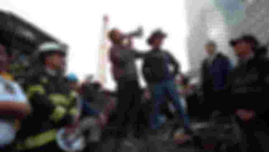 Standing atop rubble with retired New York City firefighter Bob Beckwith, President George W Bush rallies firefighters and rescue workers during an impromptu speech at the site of the collapsed World Trade Center. Image courtesy National Archives. Credit: Smith Collection/Gado/Getty Images.