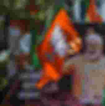 A billboard with an image of Indian Prime Minister Narendra Modi is surrounded by Bharatiya Janata Party (BJP) flags as supporters gather to celebrate election results outside the BJP headquarters in Mumbai in 2019