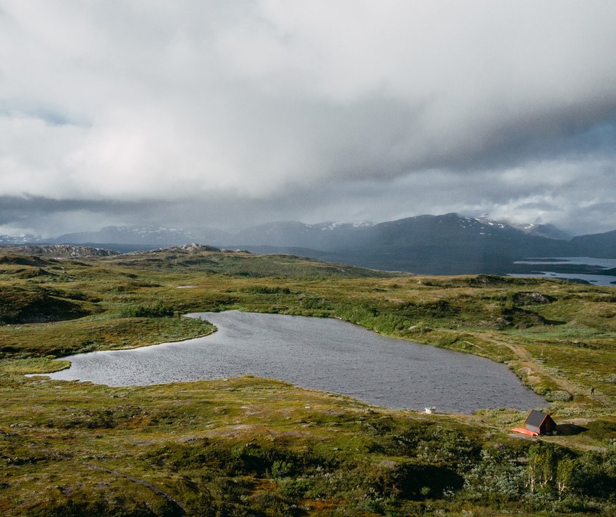badsj&ouml;n uppe p&aring; fj&auml;llet med dramatiska regnmoln i fj&auml;rran