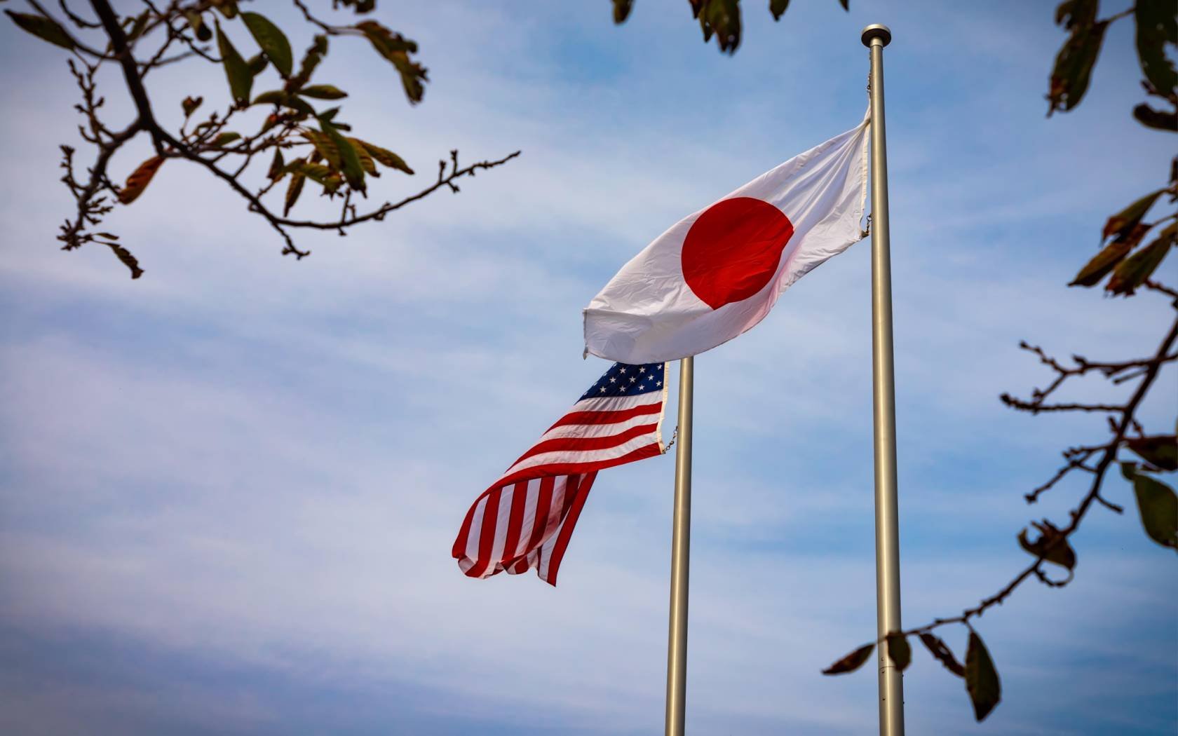 The American and Japanese flags fly side by side in Yokosuka, Japan.