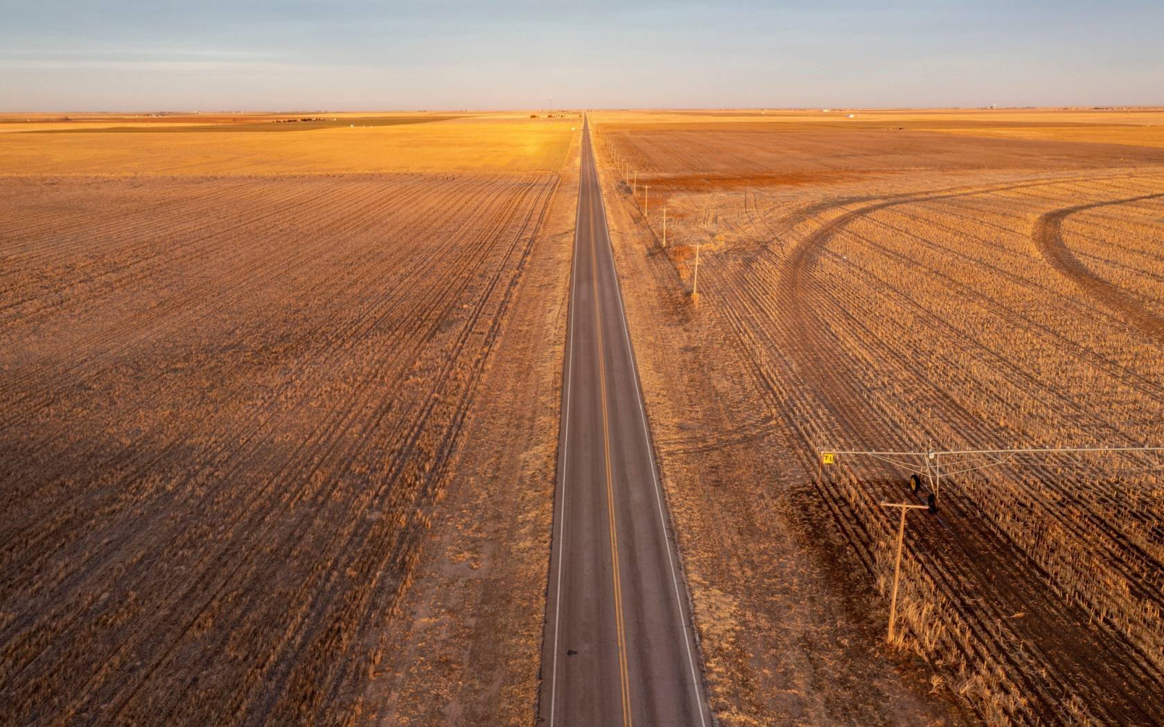 US Highway 64 runs between farms in the Oklahoma panhandle.