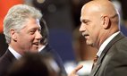 Jesse Ventura speaks with Bill Clinton at the National Governors' Association Convention, 1999. Credit: Stephen Jaffe / AFP via Getty Images.