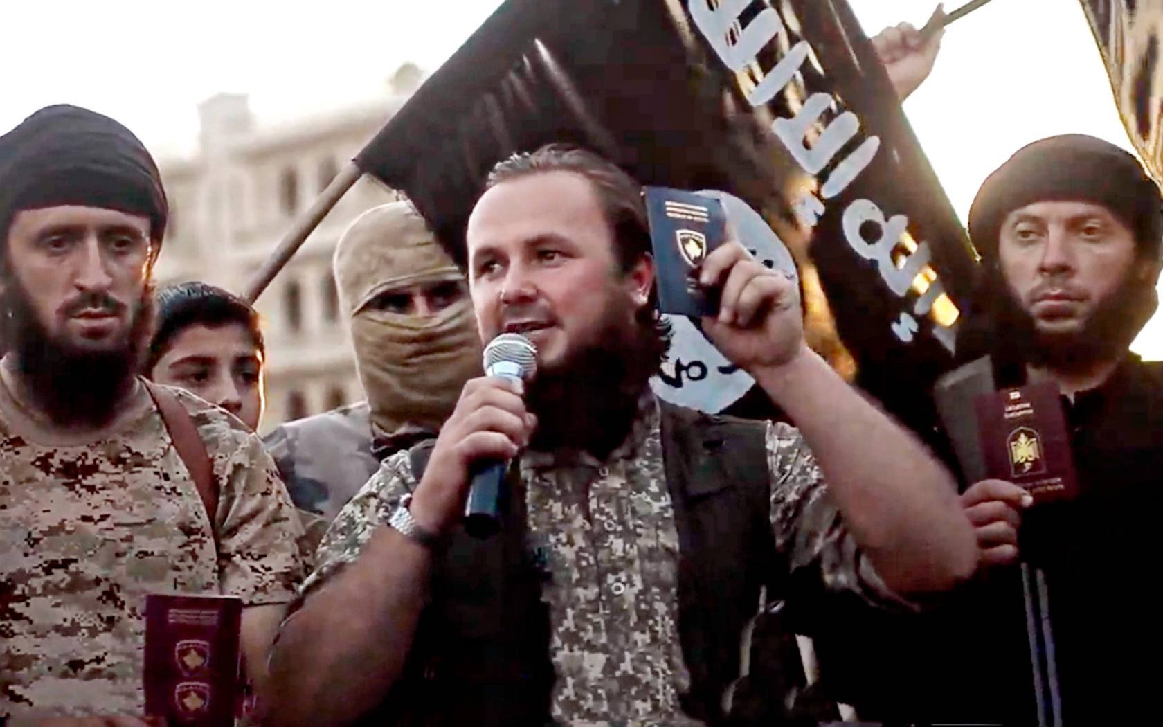 Undated propaganda video released by the Islamic State of Iraq and the Levant showing a group of foreign ISIS fighters holding up their passports as they pledge allegiance to the caliphate in Anbar Province, Iraq.