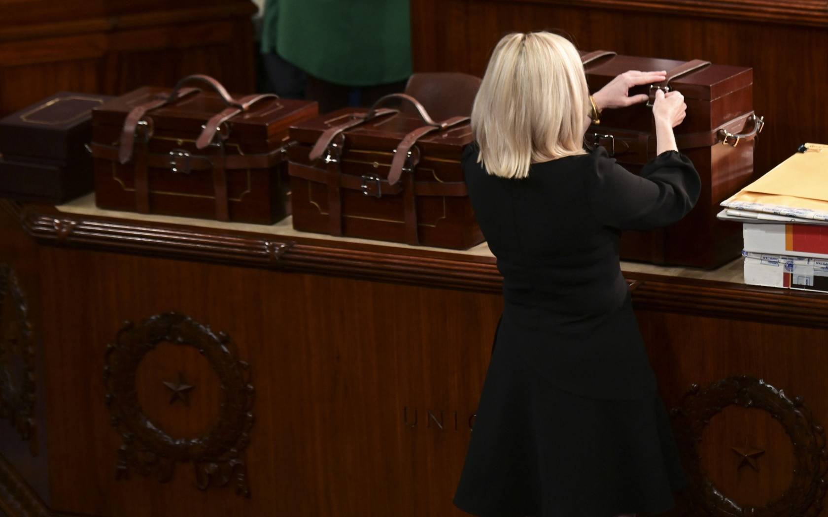 Electoral College ballot boxes from states arrive to a joint session of Congress, 6 January 2021.