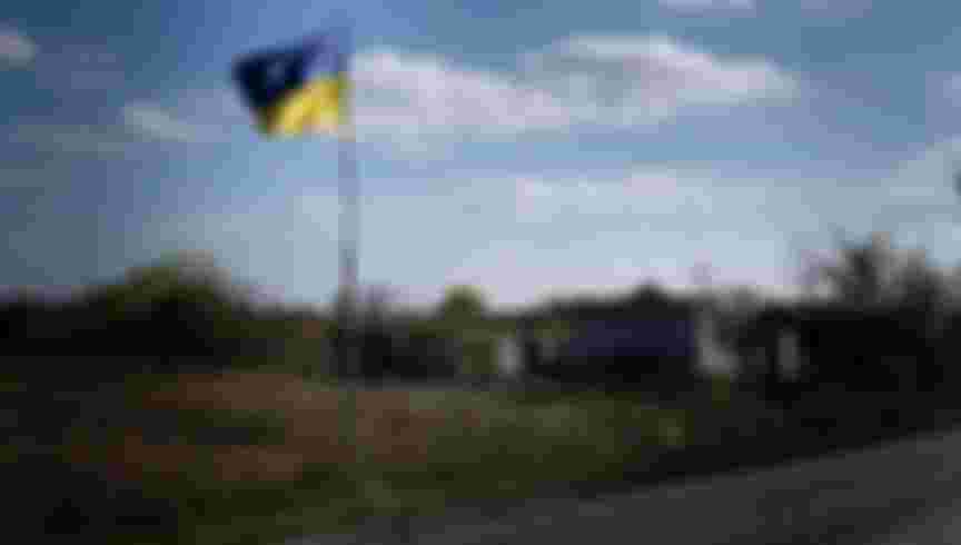 A Ukrainian flag seen fluttering near Yampil, a settlement and railroad station in Lyman, Donetsk region. The liberation of Lyman was seen as a symbolic victory in the east. Credit: Sipa US / Alamy Stock Photo.