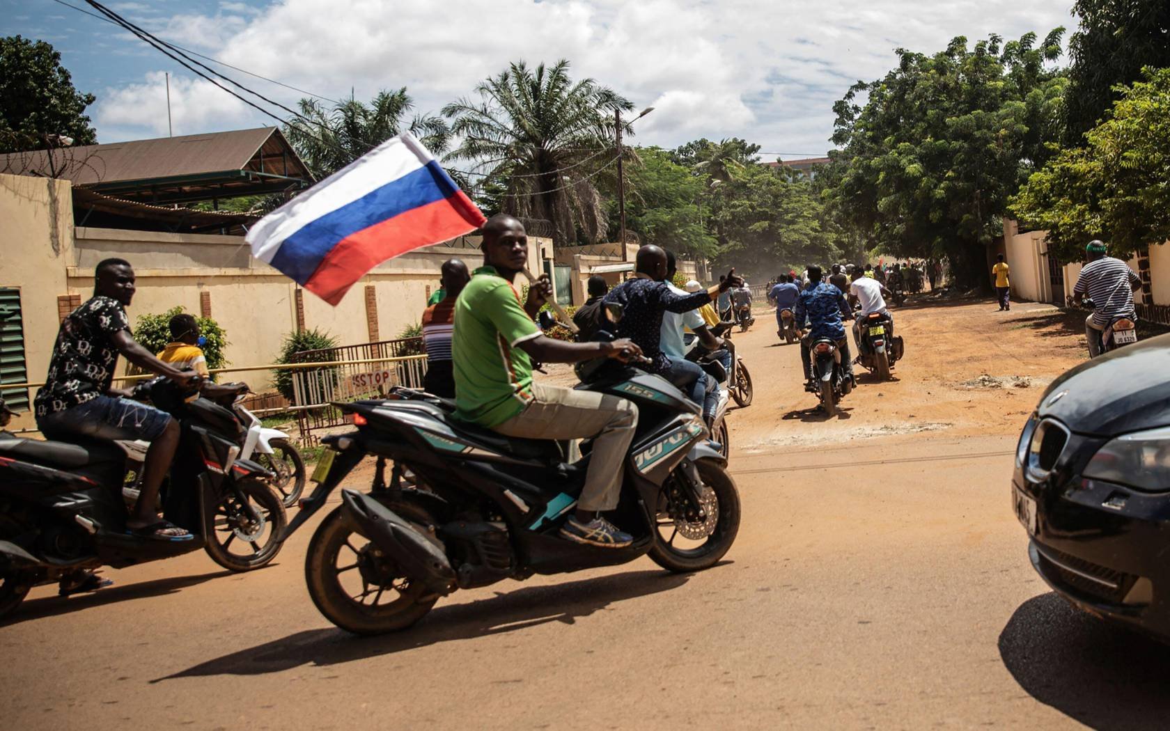 Supporters of Capt. Ibrahim Traore wave a Russian flag in the streets of Ouagadougou, Burkina Faso, 2022.