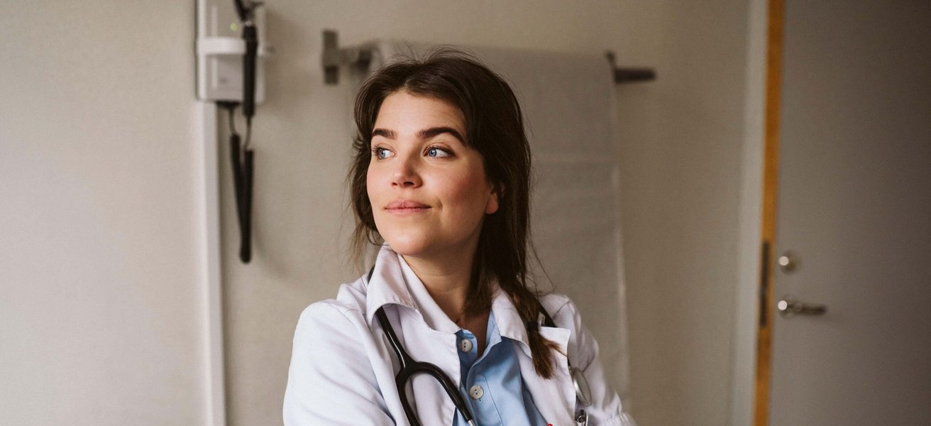 Female medical expert standing with arms crossed looking away