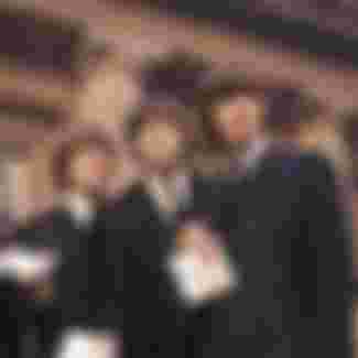 The Beatles showing their MBE Insignias after receiving them from the Queen.