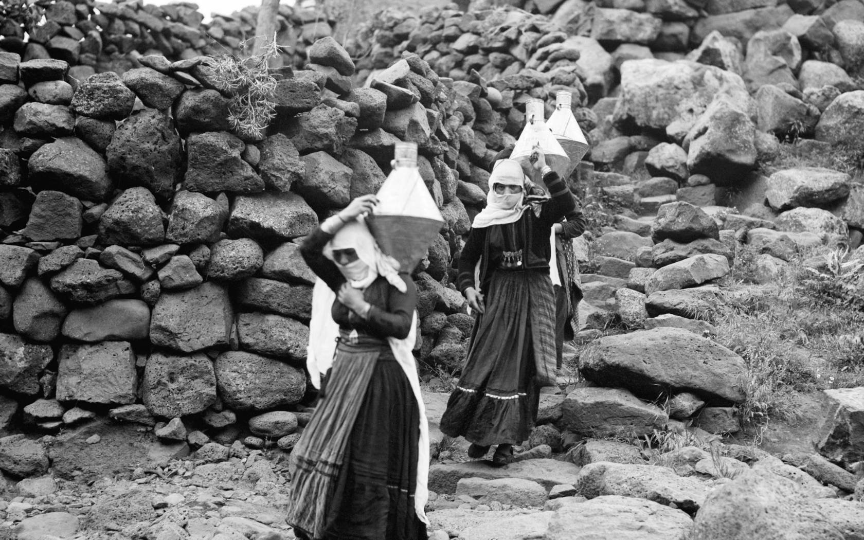 Druze women carrying water in Jabal al-Druze, Syria.