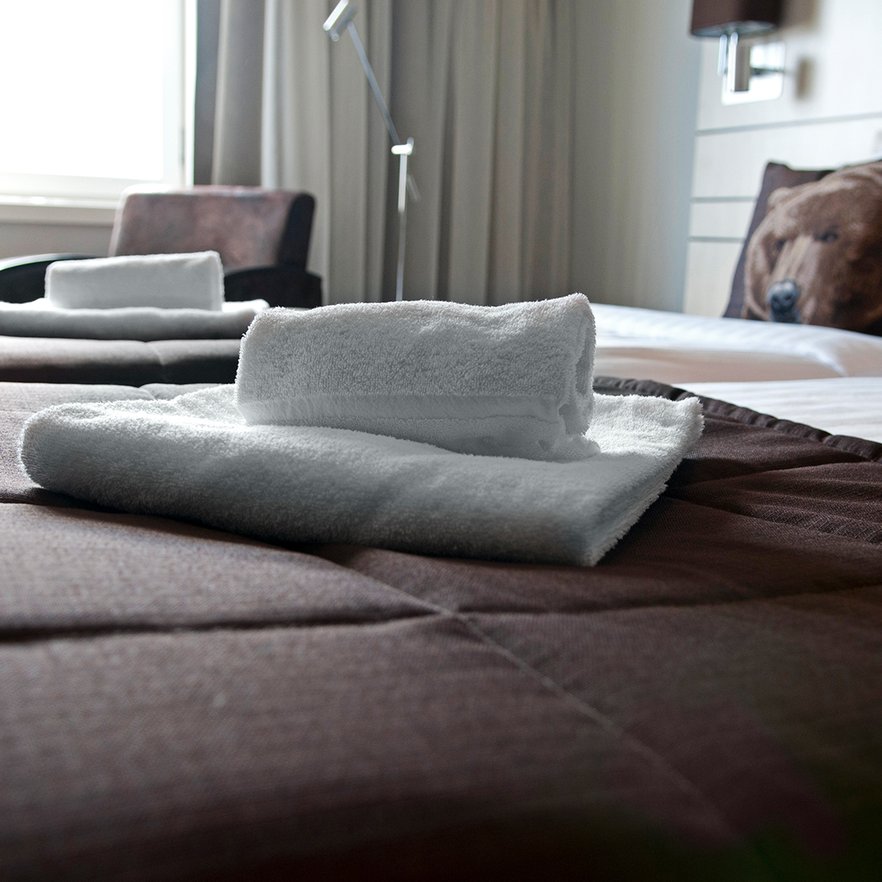 close-up of folded towels on twin-double bed