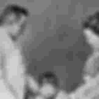 Lafcadio Hearn photographed with his wife, Setsuko Koizumi, and their son.