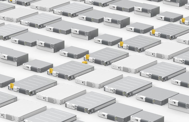 A close-up of several Polarium lithium-ion battery modules lying on a flat, white surface.
