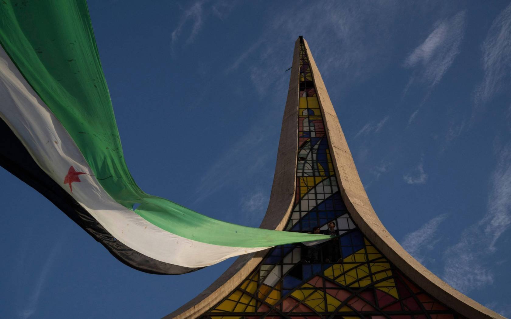 A giant Syrian flag at the Damascene Sword monument in Damascus' Umayyad Square.