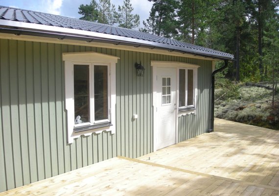 Simple green shed with accented windows