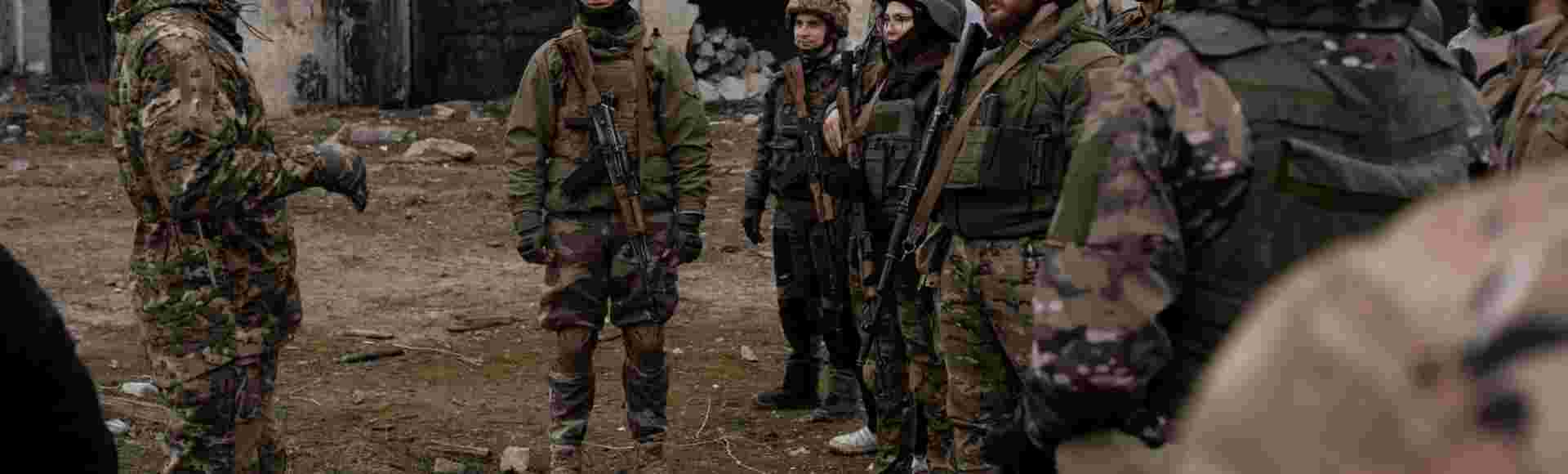 A group of trainees listens to the military instructor in a training organised by the third separate assault brigade in Kyiv, Ukraine.