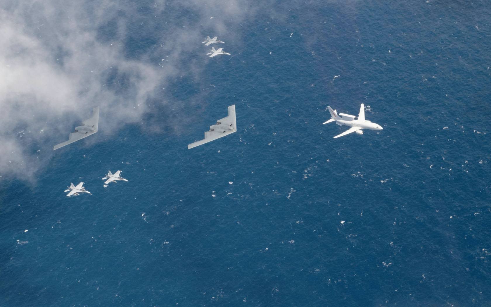 Two US Air Force B-2 Spirits fly alongside four Royal Australian Air Force EA-18G Growlers and a RAAF E-7A Wedgetail, August 2022.