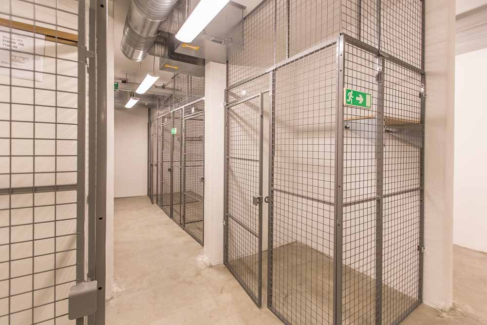 Basement storage with lockable, fenced sections.