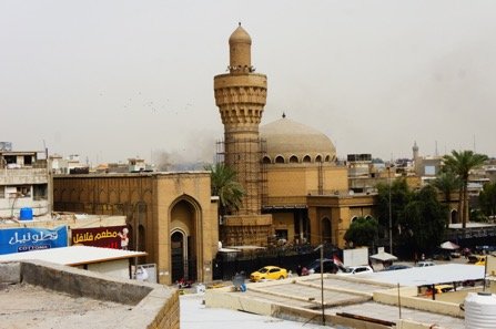The Khulufa Mosque, with the restored Abbasid minaret (centre) and Makiya's portal (left) and domed prayer hall (right). Author photograph.