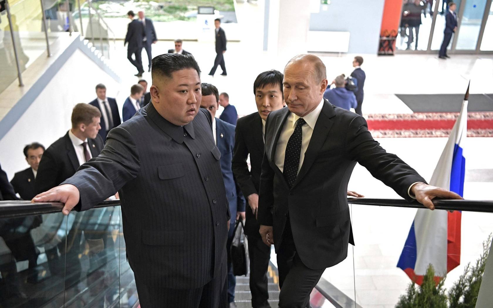 Vladimir Putin, right, with North Korean leader Kim Jong-Un on an escalator together after arriving for bilateral discussions on April 25, 2019 in Vladivostok, Russia.