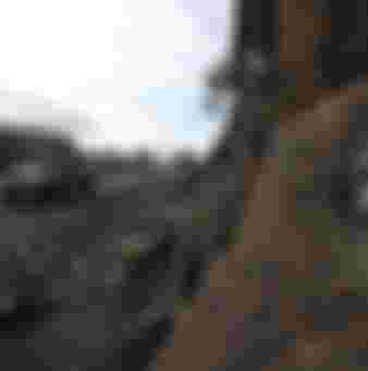 Shi'ite Houthi rebels drive a truck past an Ansar al-Sharia flag painted on the side of a hill in Almnash, the main stronghold of the local wing of Al Qaeda in the Arabian Peninsula (AQAP) in Rada, Yemen.