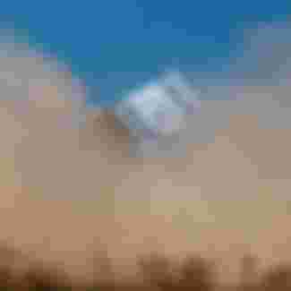 An Israeli flag is seen through a dust cloud near the border with the Gaza strip.