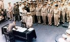 General Douglas MacArthur watches as representatives of Japan stand aboard USS Missouri prior to the signing of the Instrument of Surrender ending the Second World War.
