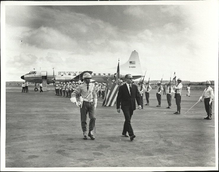 U.S. Ambassador John Tuthill being greeted by Brazilian military police in Goiâna, Brazil, in 1967.