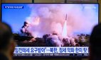 South Korean citizens watch North Korean military exercises.