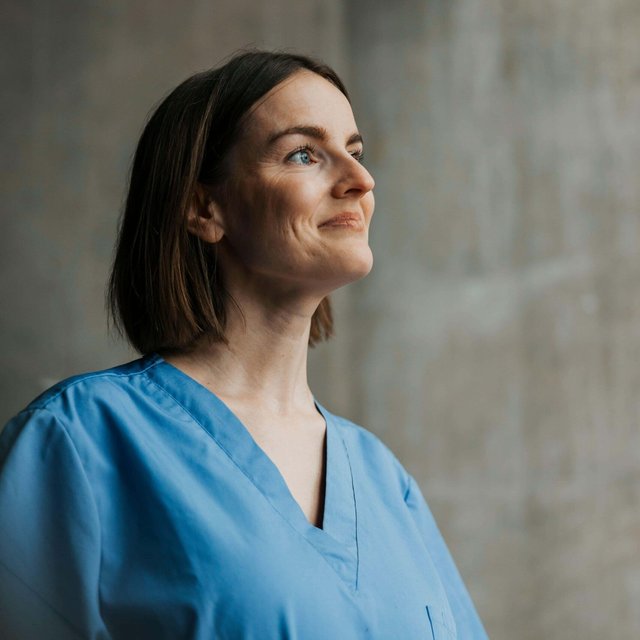 Smiling beautiful female medical professional with short hair looking away