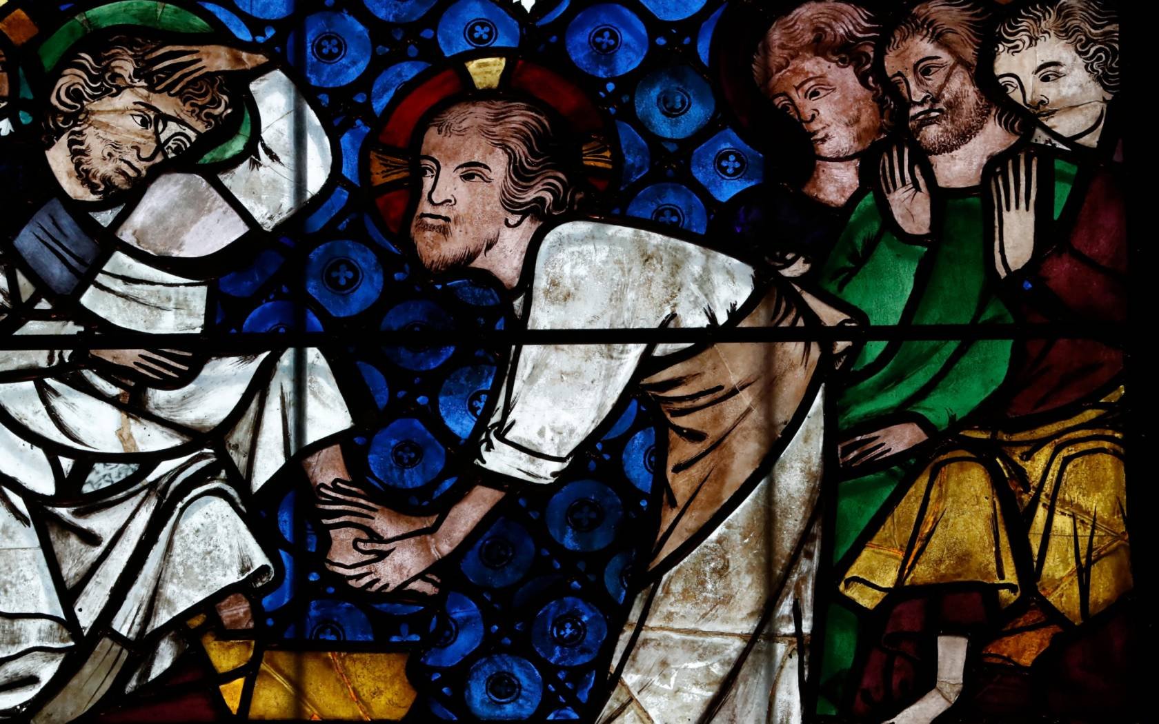 A stained glass window in Strasbourg Cathedral of Christ washing the feet of the Apostles.