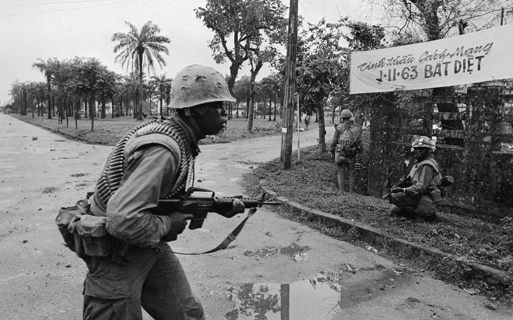 U.S. Marines with machine guns ready, watch for enemy snipers on a street in Hue on February 7th. Allied dive bombers and U.S. warships bombarded a Communist suicide battalion in Hue's walled fortress on February 15th, and American Marines and south Vietnam black panther troops charged into the flaming ruins to wipe out the Viet Cong.Getty Images