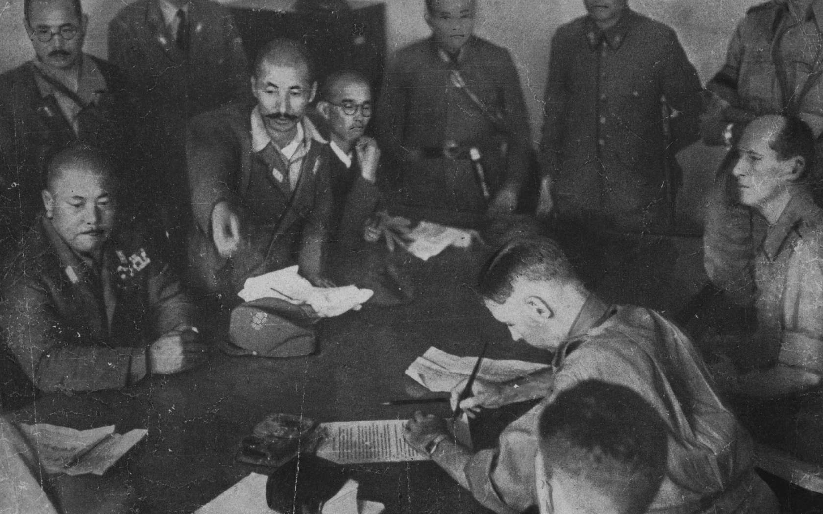 The British Commander-in-Chief, General Percival, signing surrender terms in Singapore on 15 February 15, 1942.