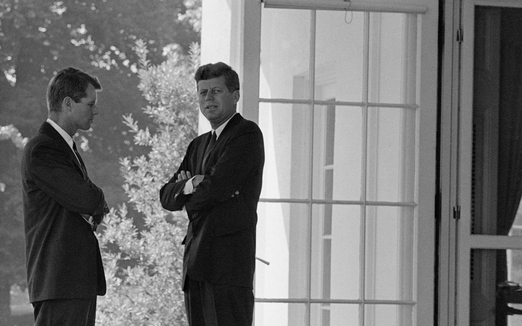 U.S. President John F. Kennedy, right, confers with his brother Attorney General Robert F. Kennedy at the White House in Washington, D.C., on October 1, 1962 during the buildup of military tensions between the U.S. and the Soviet Union that became Cuban missile crisis later that month.