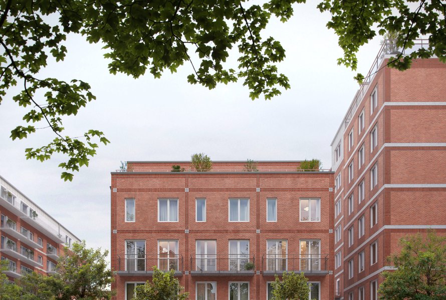 L&auml;genhetshus med tegelfasad i bostadsomr&aring;de.