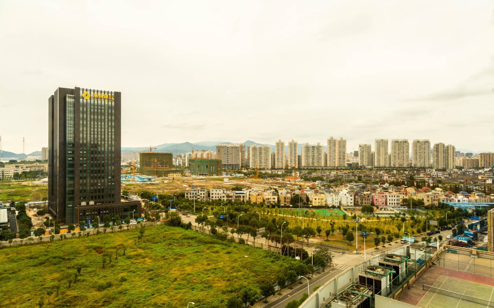 High-rise buildings replace old residences in Zhejiang, China. Credit: Charles O. Cecil / Alamy Stock Photo