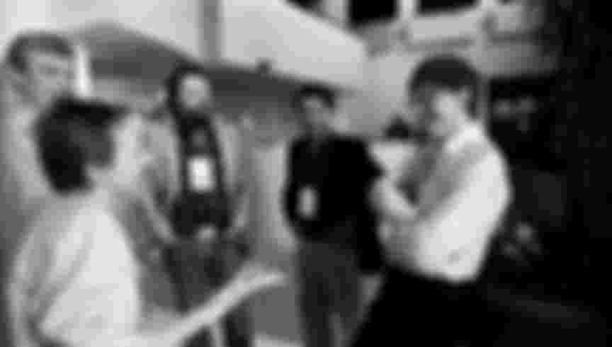 John Perry Barlow (centre, with beard) speaks with Bill Gates at the Annual PC Forum, 1991.